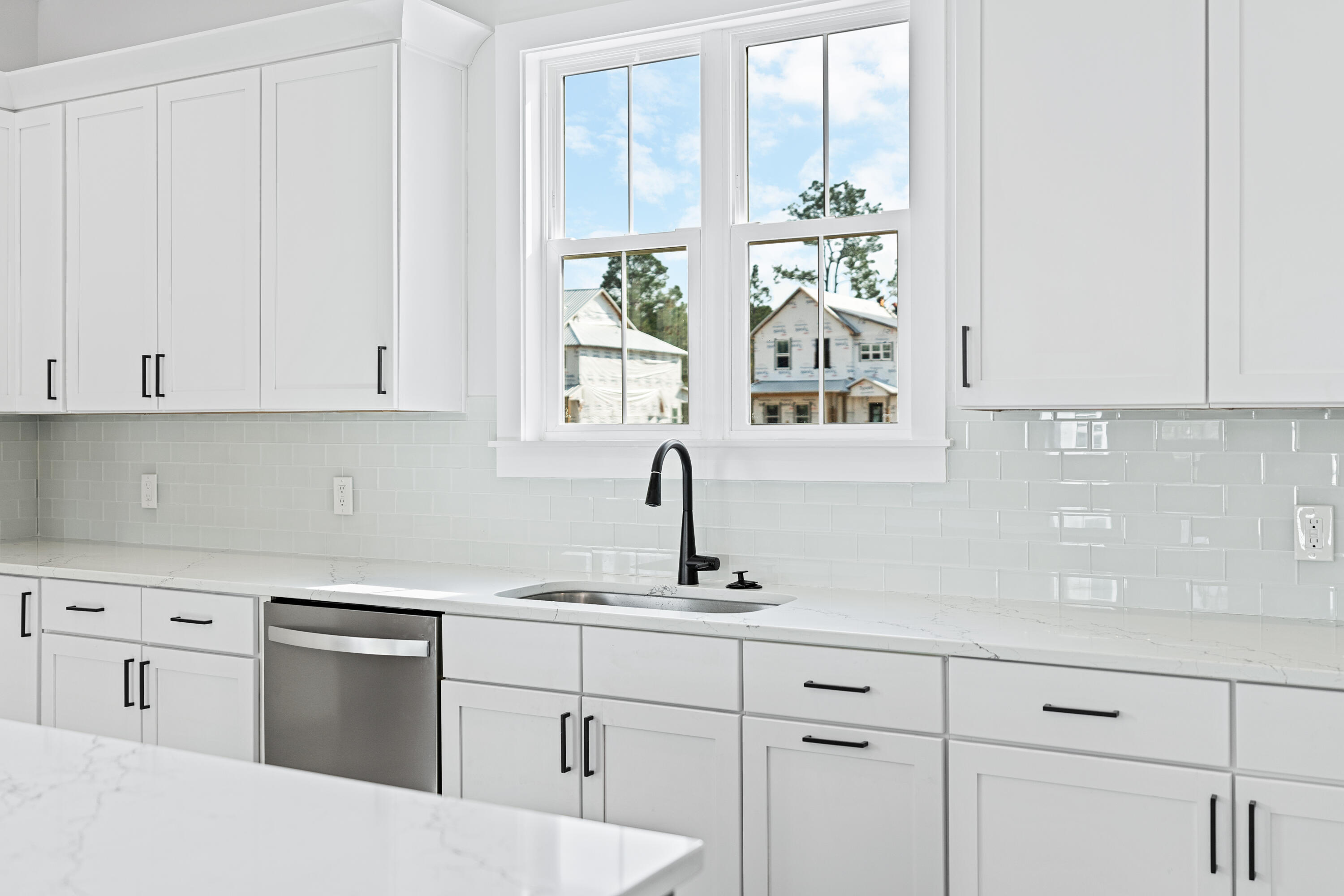 40 Mckenna Way Santa Rosa Beach, FL 32459 - Photo 31 of 61 a kitchen with white cabinets and a window