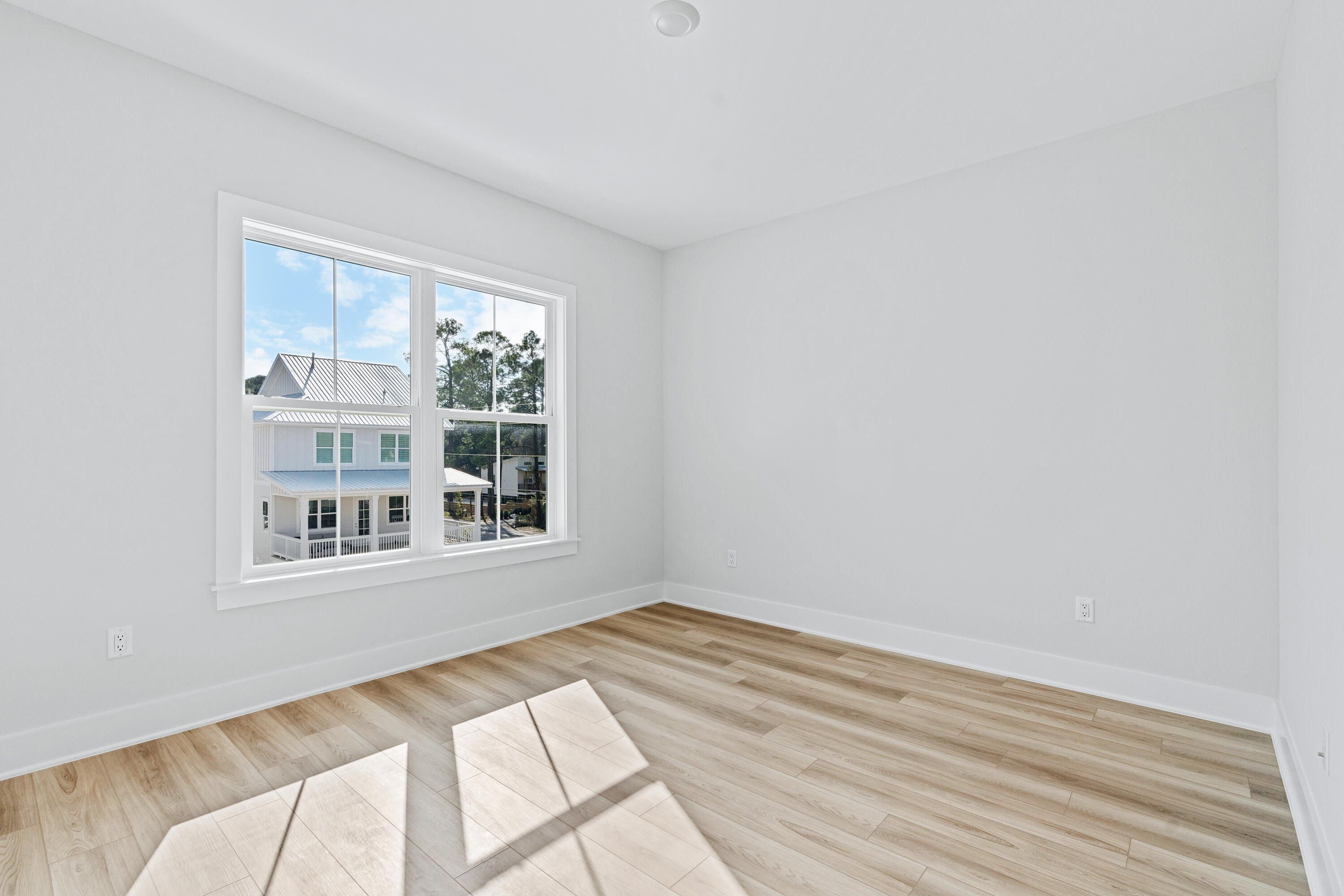 40 Mckenna Way Santa Rosa Beach, FL 32459 - Photo 47 of 61 a view of an empty room with wooden floor and a window
