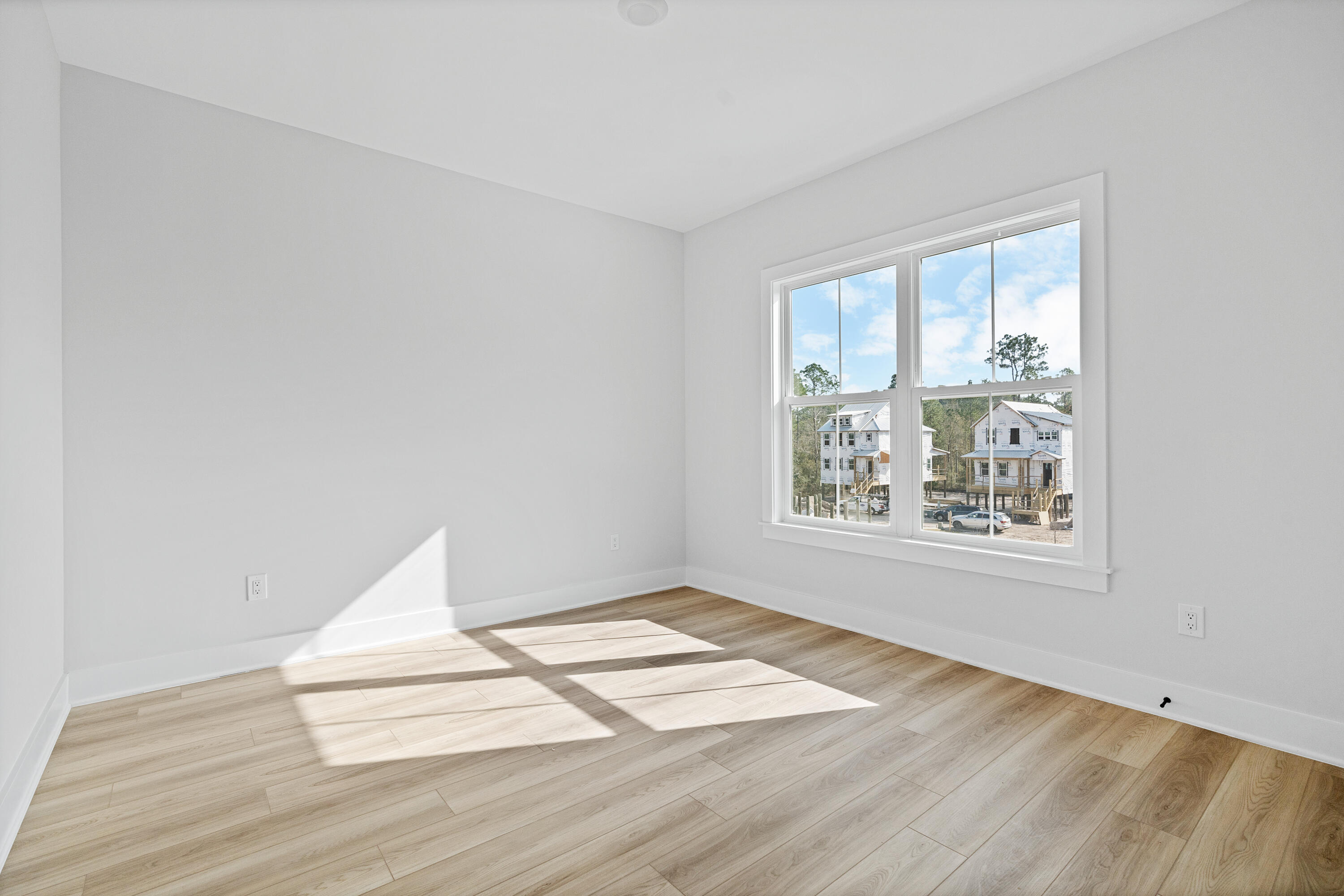 40 Mckenna Way Santa Rosa Beach, FL 32459 - Photo 49 of 61 an empty room with wooden floor and windows