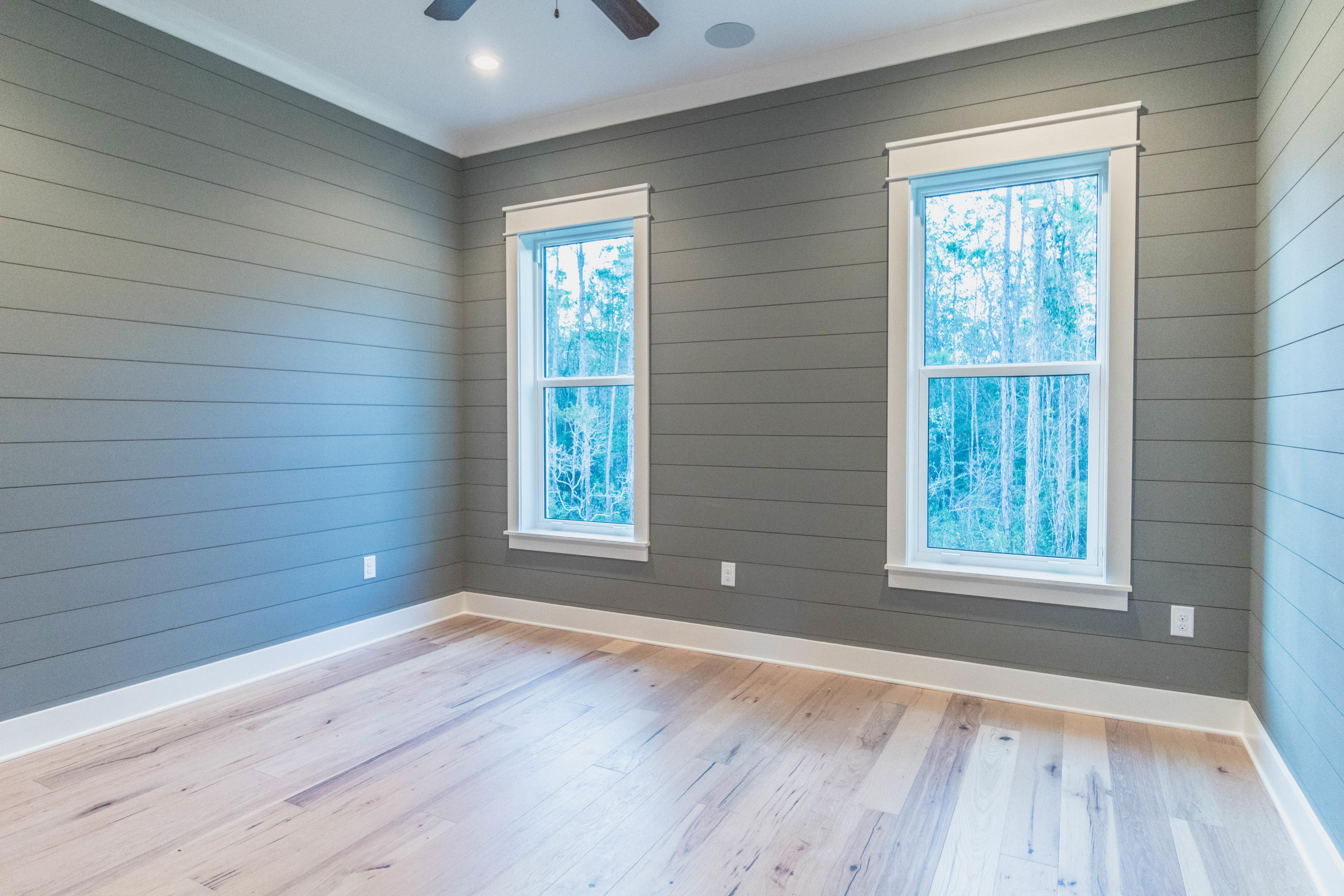 228 Ridgewalk Circle Santa Rosa Beach, FL 32459 - Photo 5 of 21 a view of an empty room with wooden floor and a window