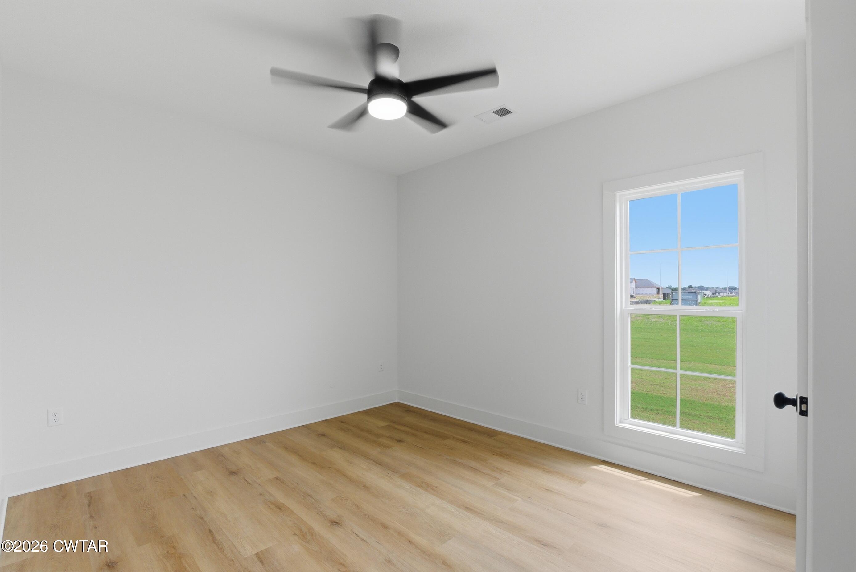 179 Daybreak Loop Medina, TN 38355 - Photo 24 of 32 an empty room with a window and ceiling fan