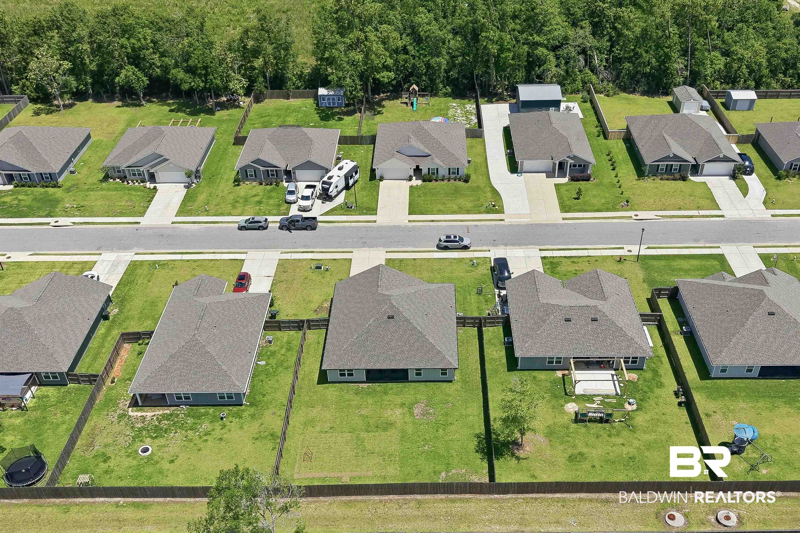3213 Camino Real Loop Lillian, AL 36549 - Photo 18 of 61 Residential neighborhood featuring multiple single-story homes with private driveways and manicured lawns