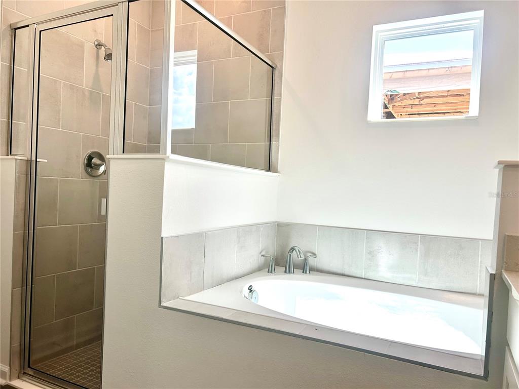 4693 Southwest 83rd Loop Ocala, FL 34476 - Photo 20 of 25 a bathroom with a tub and shower