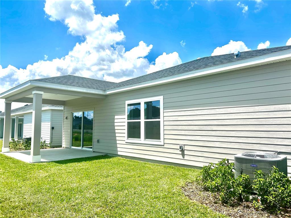 4693 Southwest 83rd Loop Ocala, FL 34476 - Photo 6 of 25 a view of a house with plants and a large tree