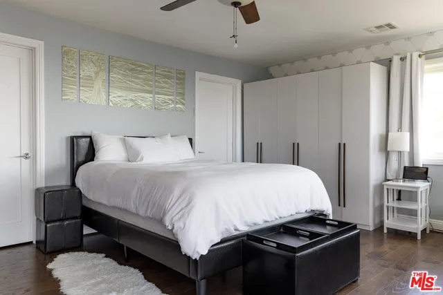 a bedroom with a large bed and a large window