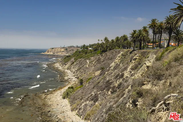 a front view of a building with a garden