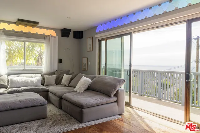 a kitchen with granite countertop a stove a sink and cabinets