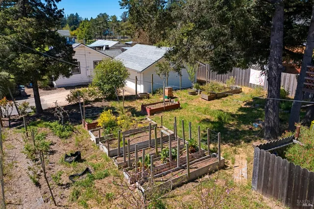 a view of a house with a yard and sitting area