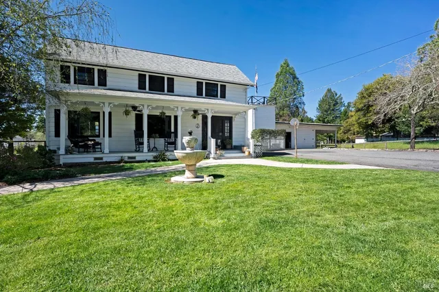 a front view of a house with a garden and plants