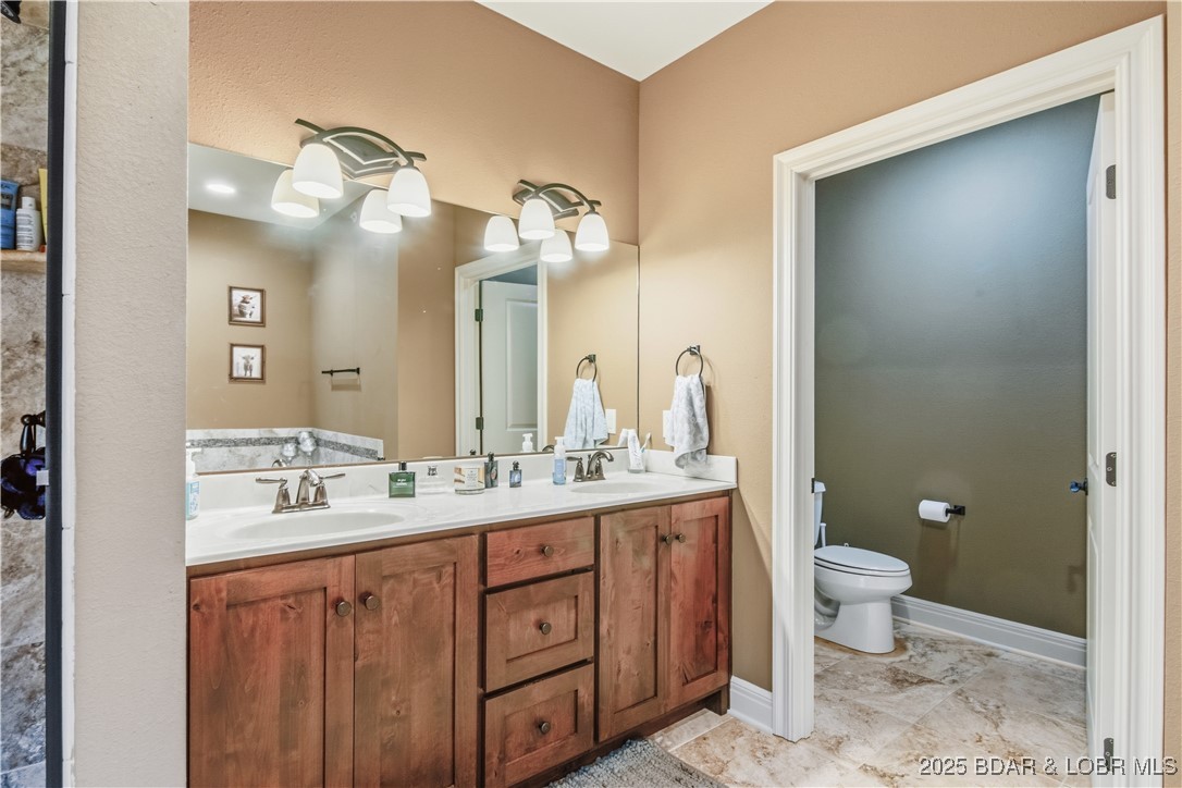 3168 Twin Rivers Point, Unit 2E Camdenton, MO 65020 - Photo 34 of 52 His and her vanities in the primary bathroom.