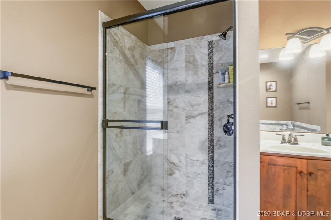 3168 Twin Rivers Point, Unit 2E Camdenton, MO 65020 - Photo 35 of 52 The tiled shower in the primary bath is stunning a