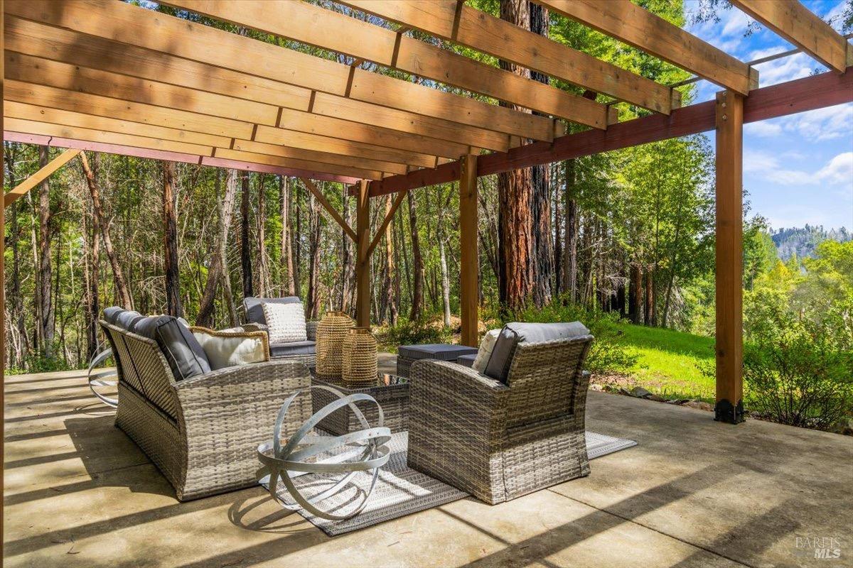 12076 Cloud Ridge Road Healdsburg, CA 95448 - Photo 40 of 72 A private patio under a pergola over looking the acreage of redwoods.