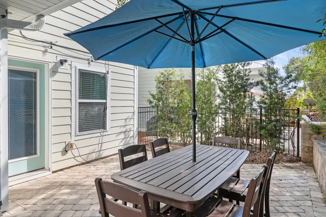 a view of a patio with table and chairs under an umbrella