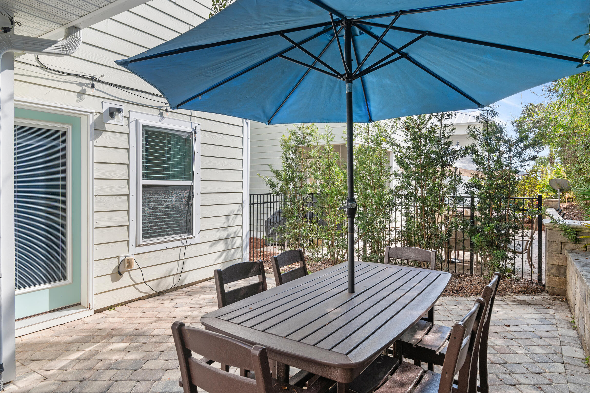 19 Charming Way Santa Rosa Beach, FL 32459 - Photo 20 of 52 a view of a patio with table and chairs under an umbrella