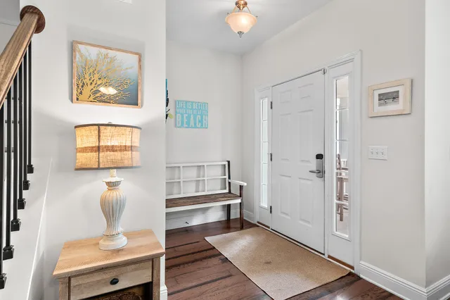 a hallway with a couch and a potted plant next to a window