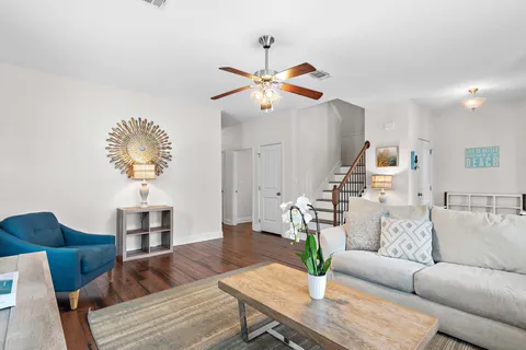 a living room with furniture and a chandelier