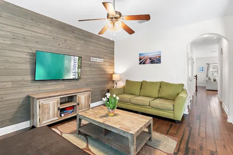 a living room with furniture a flat screen tv and a fireplace