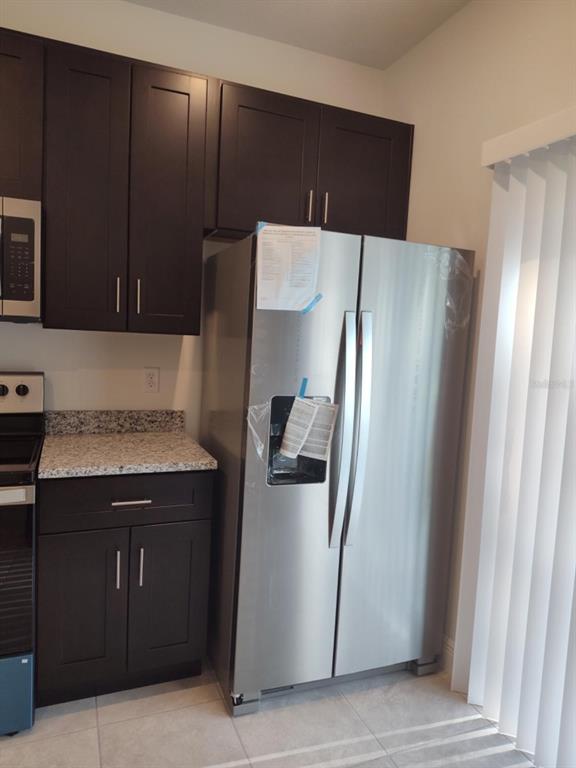 16265 Southwest 29th Court Road Ocala, FL 34473 - Photo 5 of 8 a kitchen with a refrigerator and a microwave