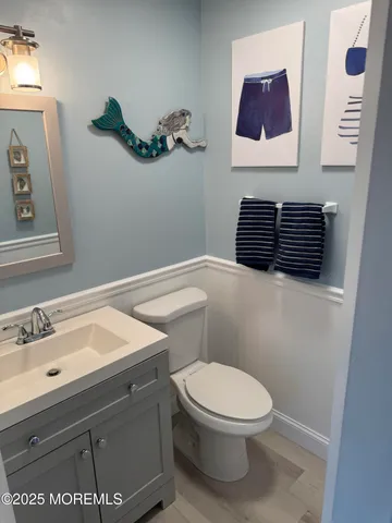 a bathroom with a toilet a sink and mirror