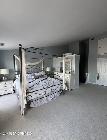 a bedroom with a bed and a chair