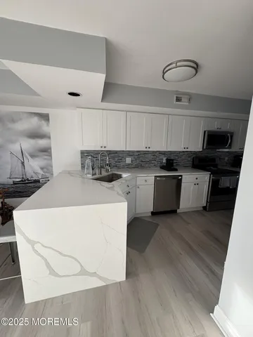 a kitchen with a sink a stove and cabinets