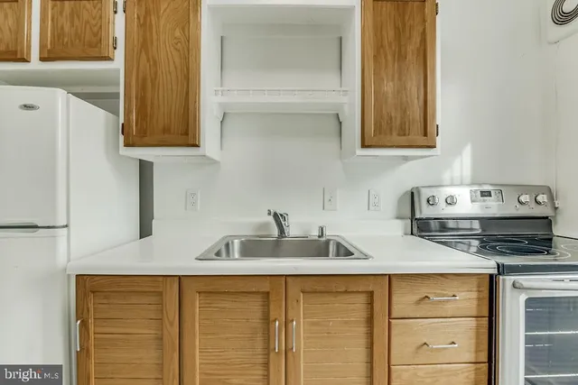a kitchen with sink and cabinets