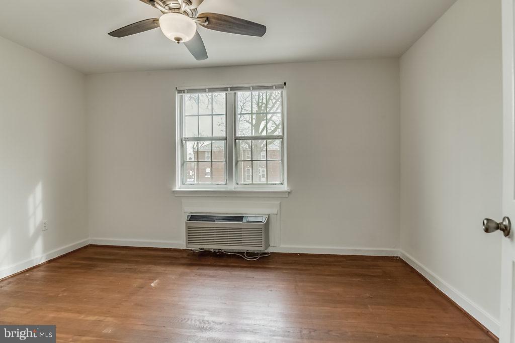 3311 Commonwealth Avenue, Unit E Alexandria, VA 22305 - Photo 15 of 31 an empty room with wooden floor and windows