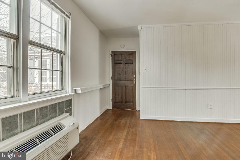 3311 Commonwealth Avenue, Unit E Alexandria, VA 22305 - Photo 5 of 31 an empty room with wooden floor and windows