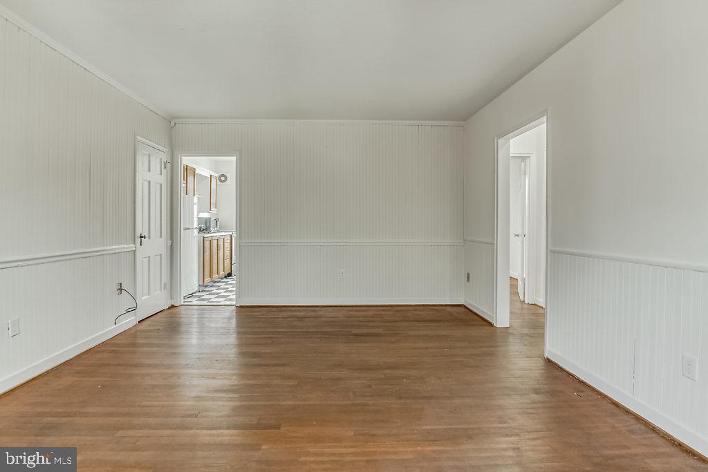 3311 Commonwealth Avenue, Unit E Alexandria, VA 22305 - Photo 7 of 31 an empty room with wooden floor and windows
