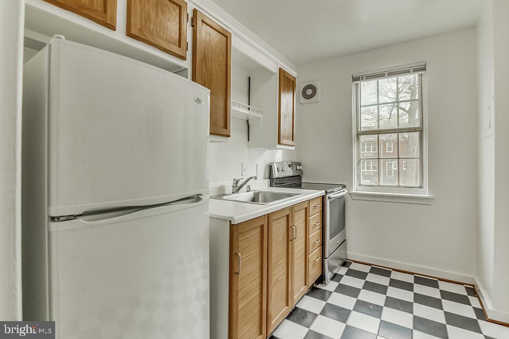 3311 Commonwealth Avenue, Unit E Alexandria, VA 22305 - Photo 9 of 31 a utility room with cabinets washer and dryer
