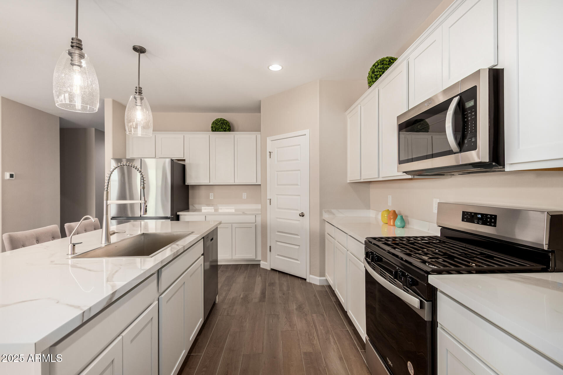 2475 West Spaulding Avenue Apache Junction, AZ 85120 - Photo 15 of 58 a kitchen with stainless steel appliances granite countertop a sink stove and microwave