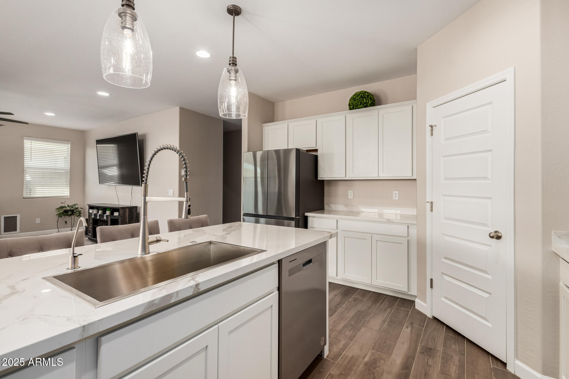 2475 West Spaulding Avenue Apache Junction, AZ 85120 - Photo 17 of 58 a kitchen with kitchen island white cabinets and refrigerator