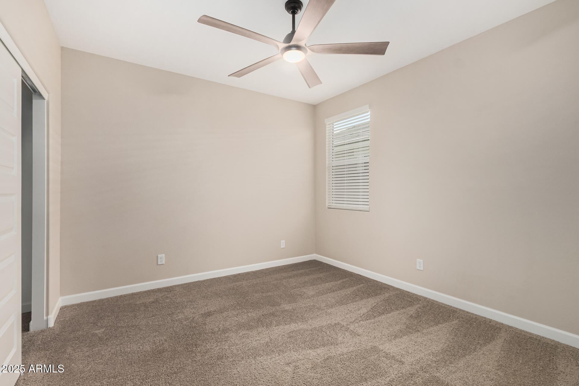 2475 West Spaulding Avenue Apache Junction, AZ 85120 - Photo 29 of 58 an empty room with a window and a fan
