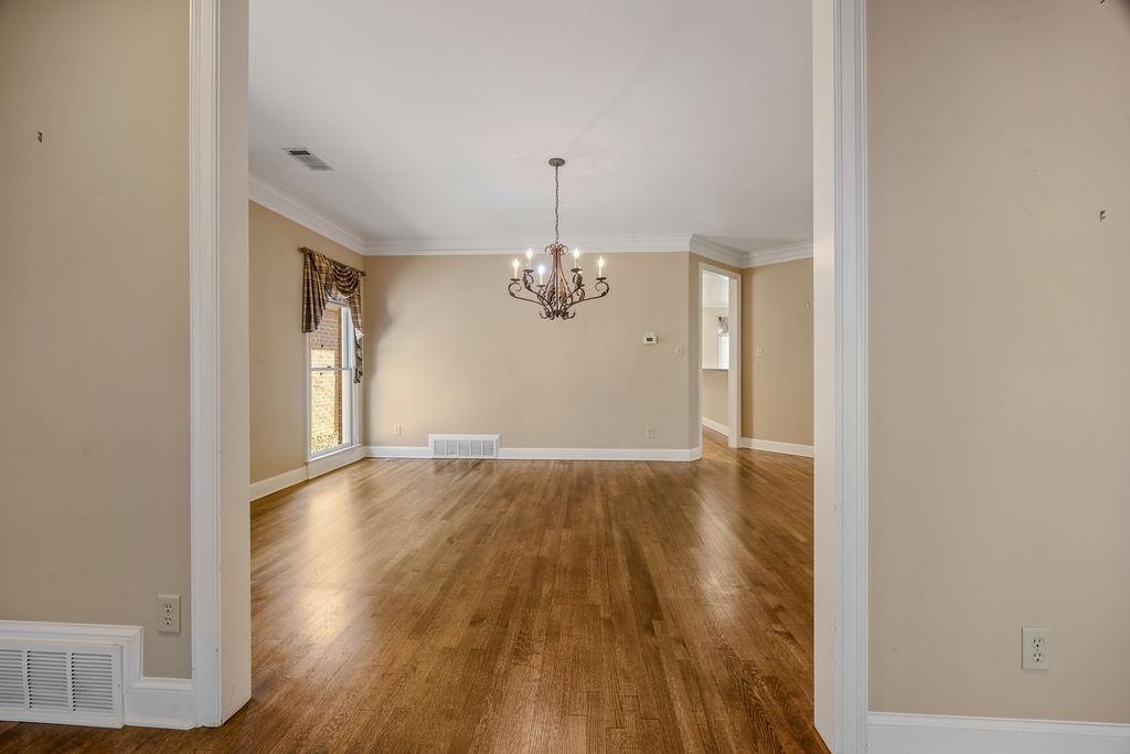8009 Fox Fern Road Germantown, TN 38138 - Photo 11 of 40 a view of a room with wooden floor and chandelier