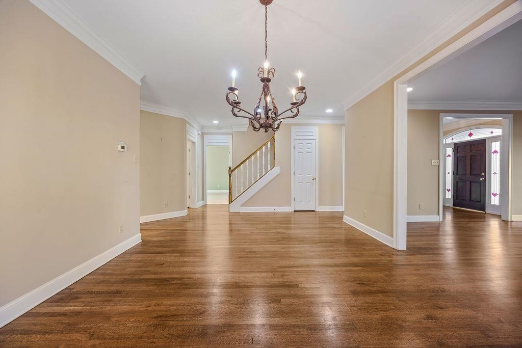 8009 Fox Fern Road Germantown, TN 38138 - Photo 14 of 40 a view of a room with wooden floor staircase and a chandelier