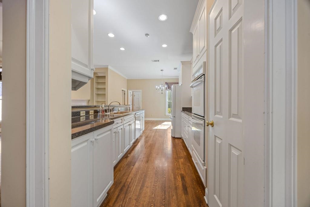 8009 Fox Fern Road Germantown, TN 38138 - Photo 21 of 40 a view of a kitchen with a sink and wooden floor
