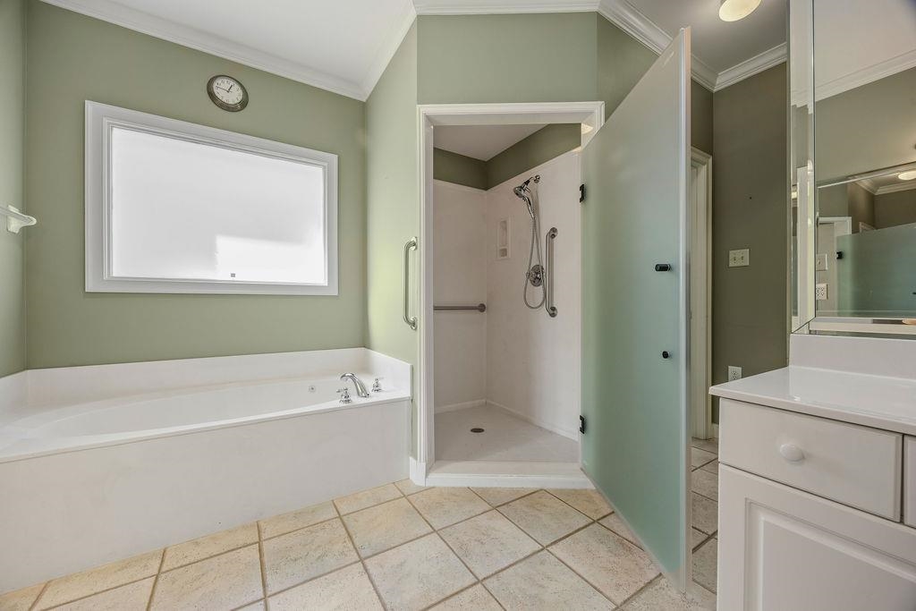 8009 Fox Fern Road Germantown, TN 38138 - Photo 31 of 40 a bathroom with a bathtub a sink and a shower