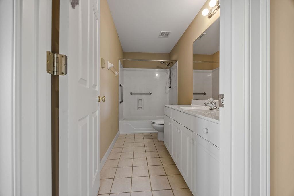 8009 Fox Fern Road Germantown, TN 38138 - Photo 39 of 40 a bathroom with a granite countertop sink a mirror and a shower