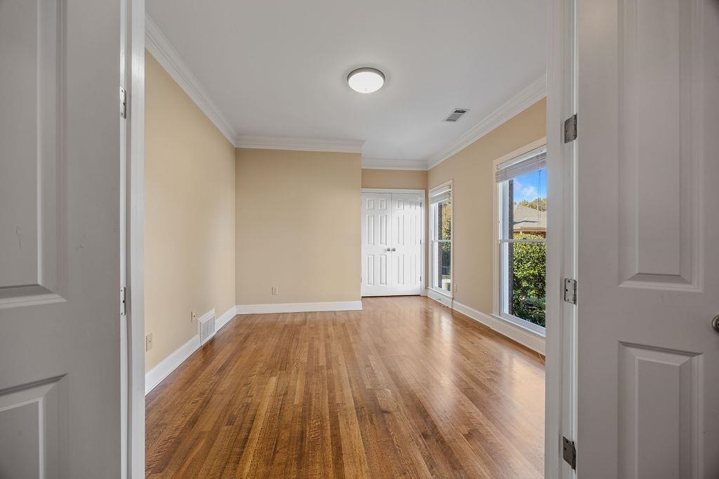 8009 Fox Fern Road Germantown, TN 38138 - Photo 6 of 40 a view of an empty room with wooden floor and a window