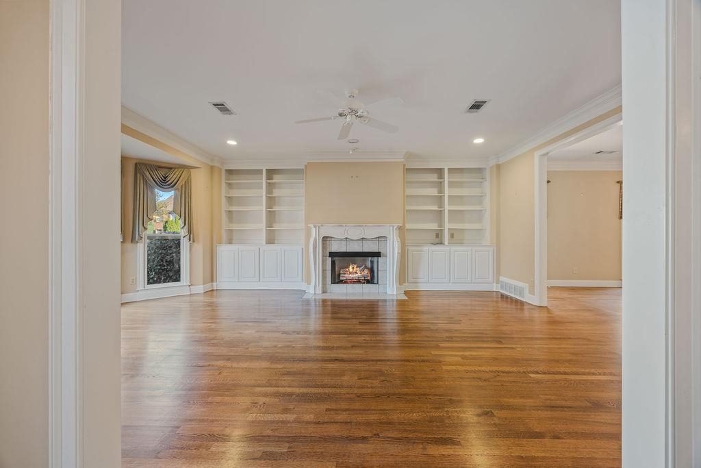 8009 Fox Fern Road Germantown, TN 38138 - Photo 8 of 40 a view of an empty room with a fireplace and a window