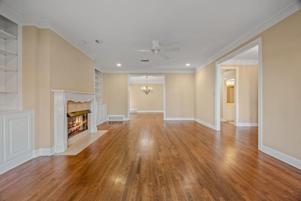 8009 Fox Fern Road Germantown, TN 38138 - Photo 10 of 40 wooden floor in an empty room with a fireplace