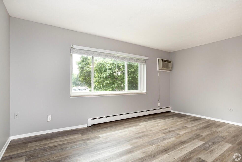 101 Lafayette Road Syracuse, NY 13205 - Photo 13 of 25 an empty room with wooden floor and windows