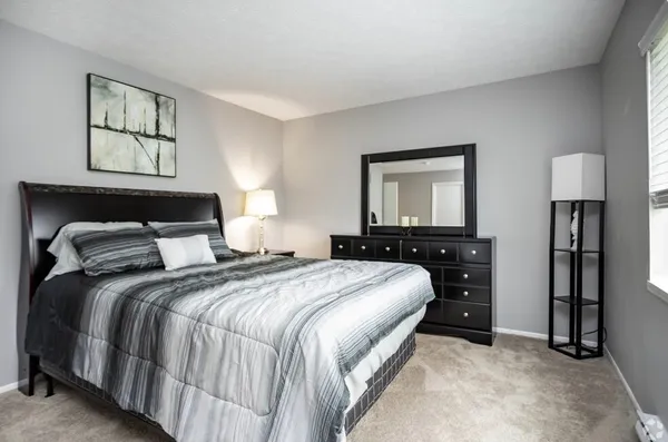 a bedroom with a bed and a lamp