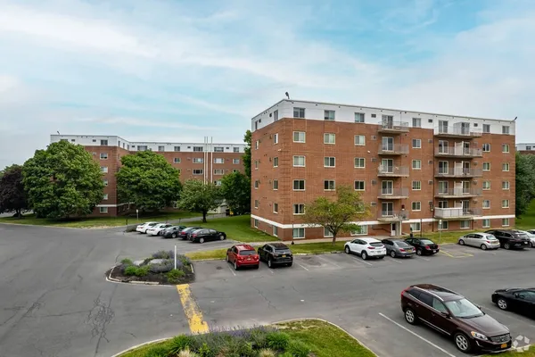 a city street lined with parked cars and buildings