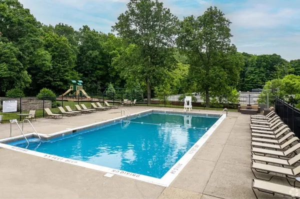 a view of swimming pool with chairs