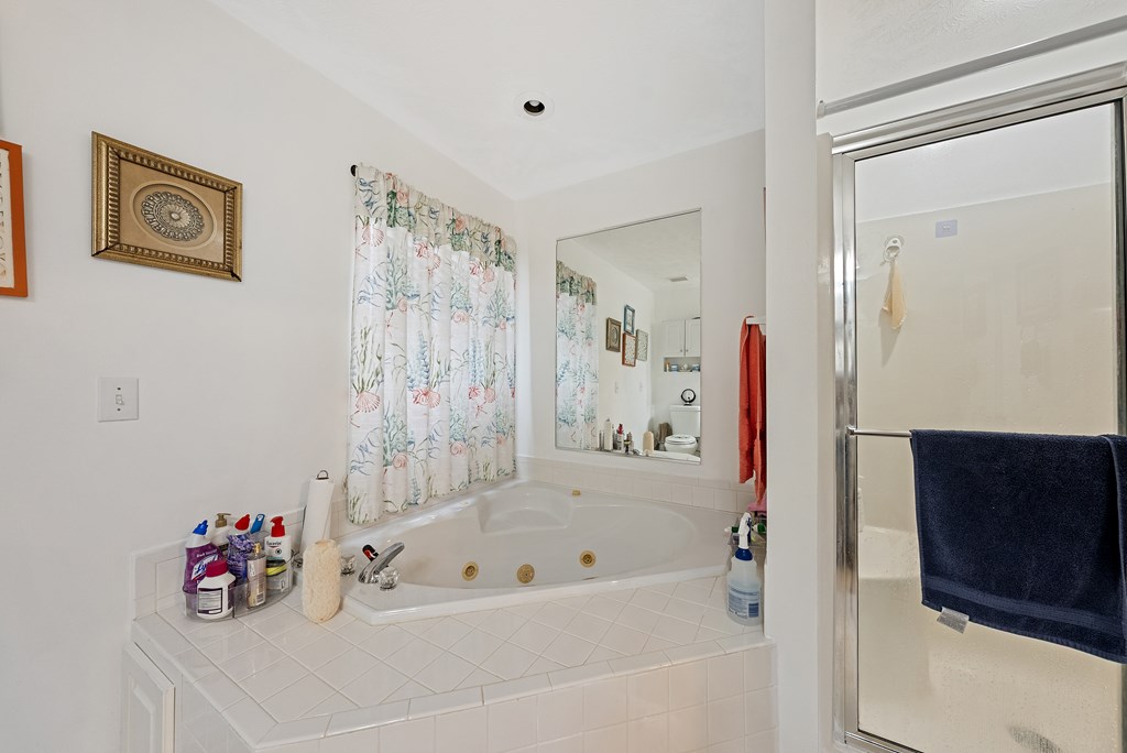 370 Evergreen Drive Fortson, GA 31808 - Photo 17 of 32 a bathroom with a bathtub a shower and a sink