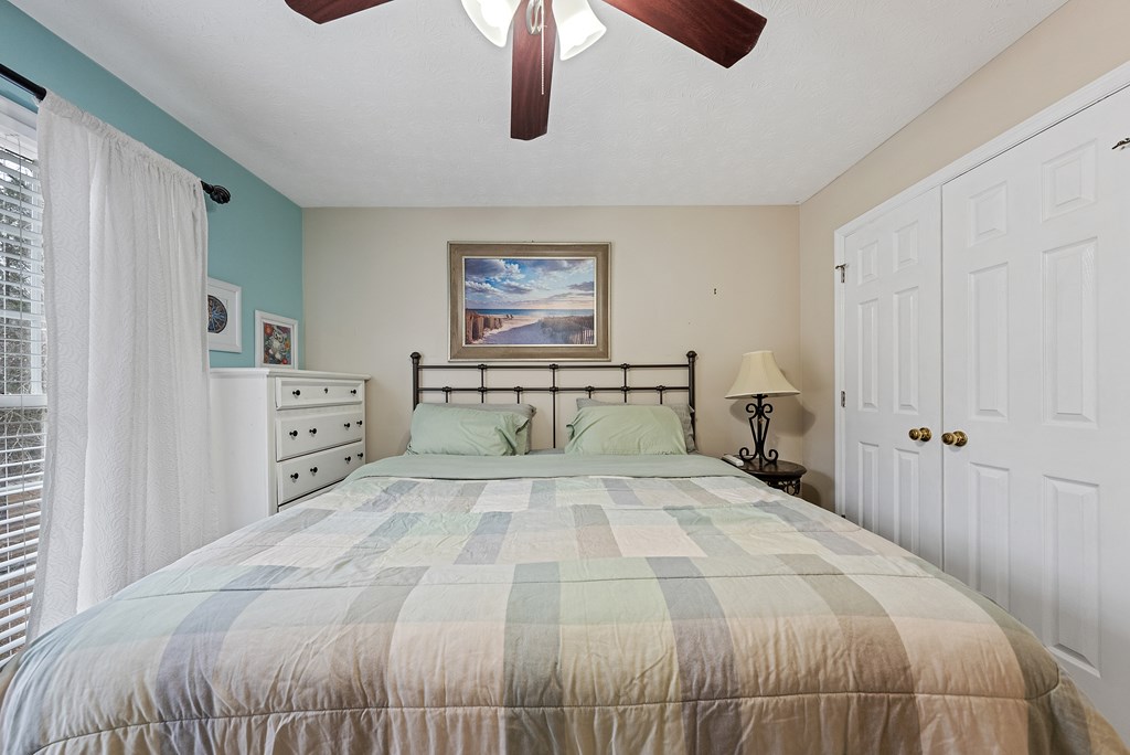 370 Evergreen Drive Fortson, GA 31808 - Photo 19 of 32 a bedroom with a large bed and a chandelier