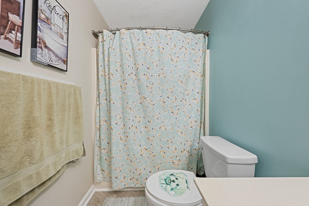 370 Evergreen Drive Fortson, GA 31808 - Photo 21 of 32 a bathroom with a toilet and a shower curtain
