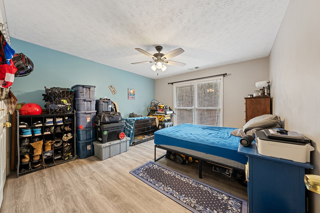 370 Evergreen Drive Fortson, GA 31808 - Photo 22 of 32 a bedroom with furniture and a chandelier