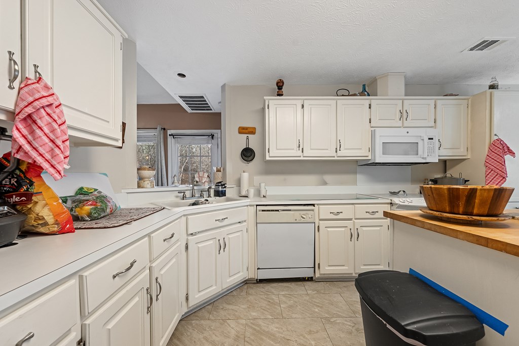 370 Evergreen Drive Fortson, GA 31808 - Photo 8 of 32 a kitchen with stainless steel appliances granite countertop a sink and cabinets